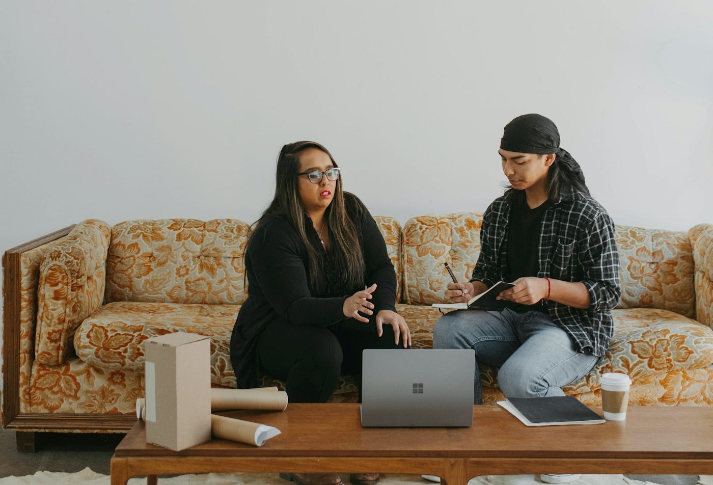 A couple at a table with a laptop
