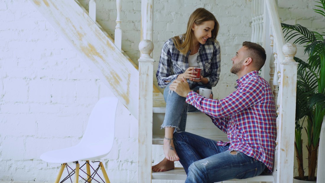 A couple on a staircase, a little apart