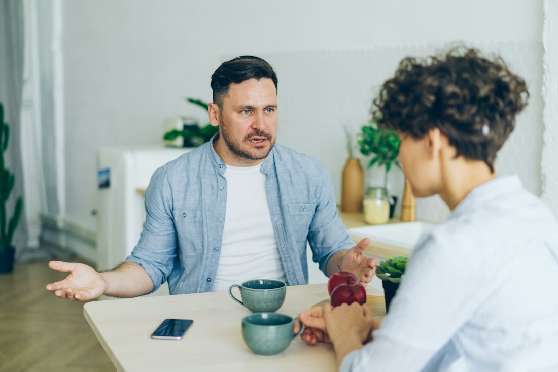 Two people talking across a table